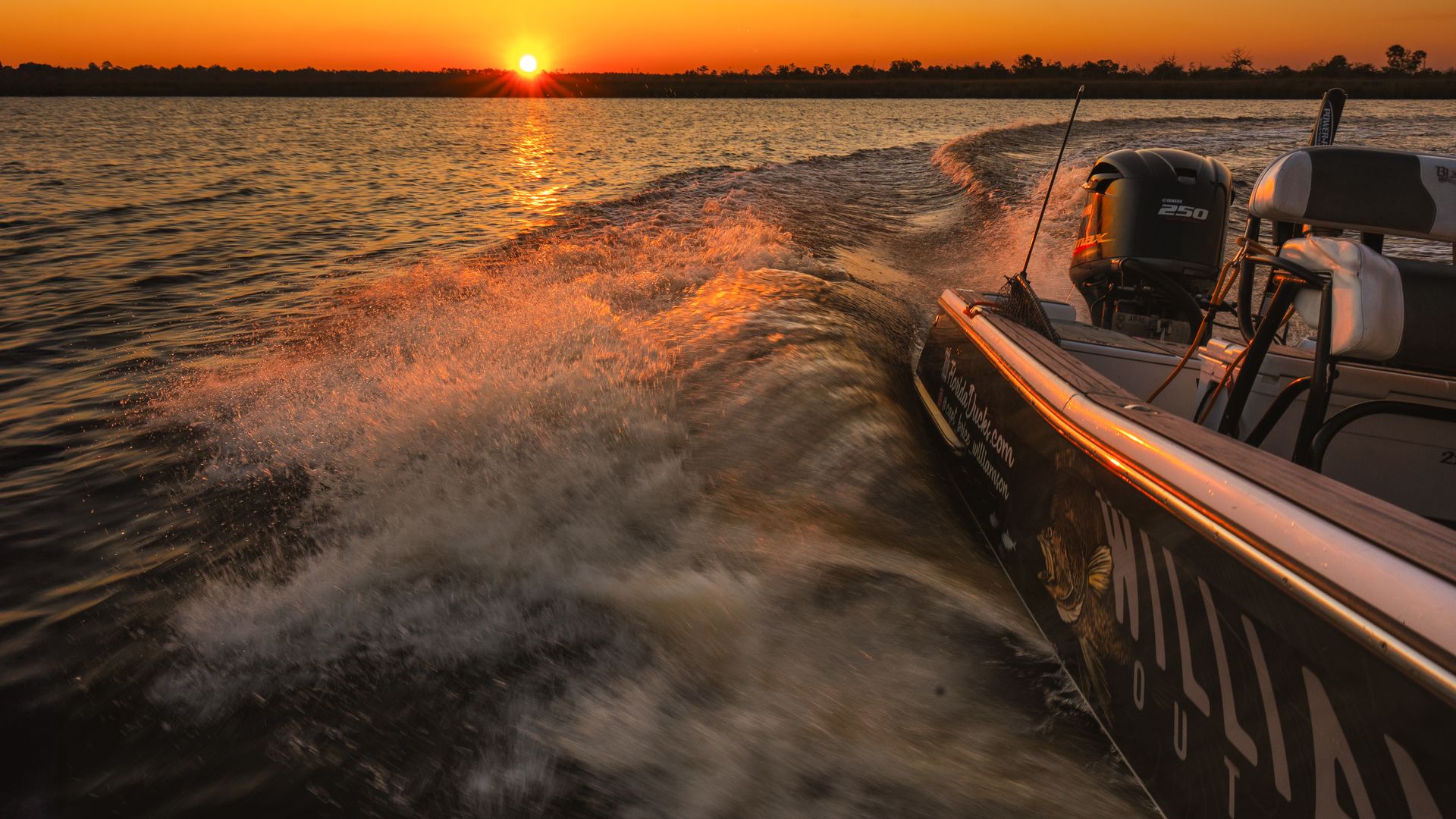 Boat wake at golden sunset